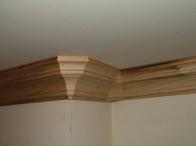 The light-colored triangular piece of crown molding on the outside corner makes all of the difference. You can also see one in the inside corner as well. It only took 10 more minutes to make these extra cuts. PHOTO CREDIT: Tim Carter