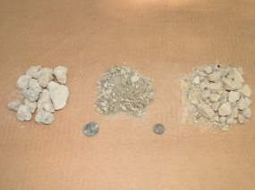 Here are three piles of crushed stone. The one on the left is just larger pieces of crushed rock. The middle pile are the fines. The pile on the right is the crushed rock mixed with the fines. The larger coin on the left is a quarter and the smaller coin is a dime. PHOTO BY: Tim Carter