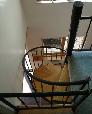 This five-foot wide set of spiral stairs has been heavily used for nearly 20 years. The oak treads are screwed to the metal treads making for a classy, yet contemporary look. PHOTO CREDIT: Tim Carter