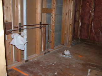 This bathroom has been stripped to the studs. Plumbing pipes must be moved and new electric wires installed because the sink and tub are being relocated within the room. PHOTO CREDIT: Tim Carter