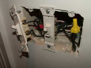 Be sure the screws that secure electrical wires to outlets and switches are tight. PHOTO CREDIT: Tim Carter
