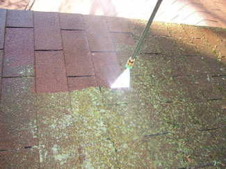 You can use a pressure washer to clean moss, lichens and algae from asphalt shingle roofs. But, you must be careful! PHOTO CREDIT: Brent Walker