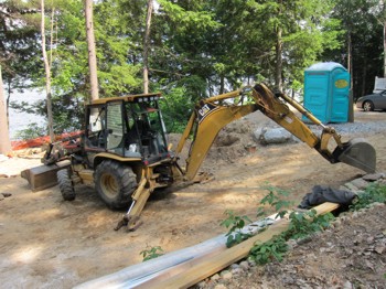A smaller backhoe like this can be used to dig small basement and cellar holes but don’t use them for big holes. These machines are really made for digging trenches. PHOTO CREDIT:  Tim Carter