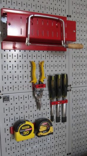 This is my favorite pegboard and hook system. The pegboard is metal and the hooks will NEVER come out when you take a tool from the wall.  Photo Credit: Tim Carter