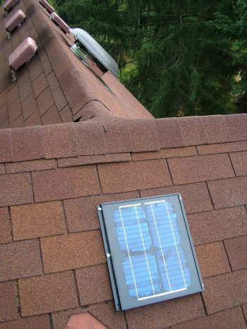 This is the solar panel that produces the electricity to run my attic ventilation fan. You can see the round dome of the fan on the other roof slope. It is different looking from the visible brown static pot vents that do not have fans working to remove the hot air. PHOTO CREDIT: Tim Carter