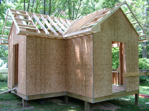 This photo was taken July 8, 2005. The shed was started on June 23, 2005. 99% of the work has been done by me with no help whatsoever. Add in the heat and humidity and you can see why it is taking so long. But I am having a blast. It is really a lot of fun. PHOTO BY: Tim Carter
